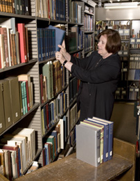 Archivist retrieves book for research